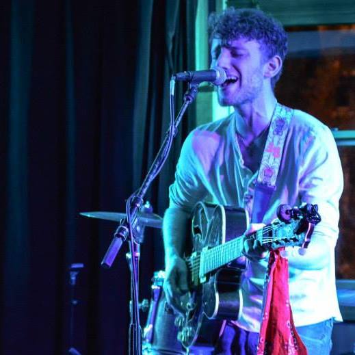 Jordan singing with guitar